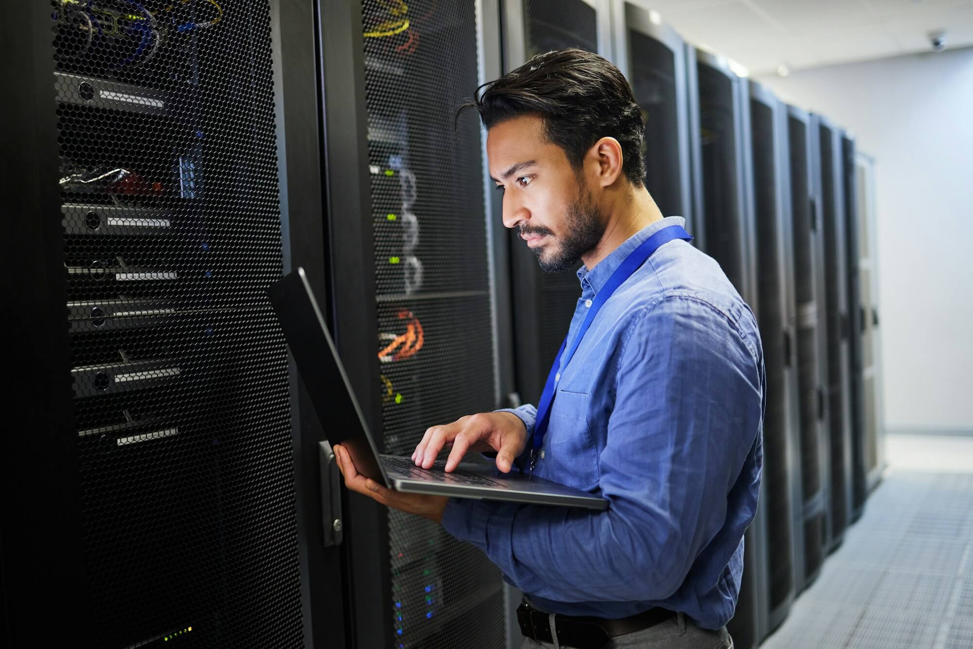 programming-data-center-and-a-man-with-a-laptop-for-maintenance-cyber-security-and-internet-check.jpg
