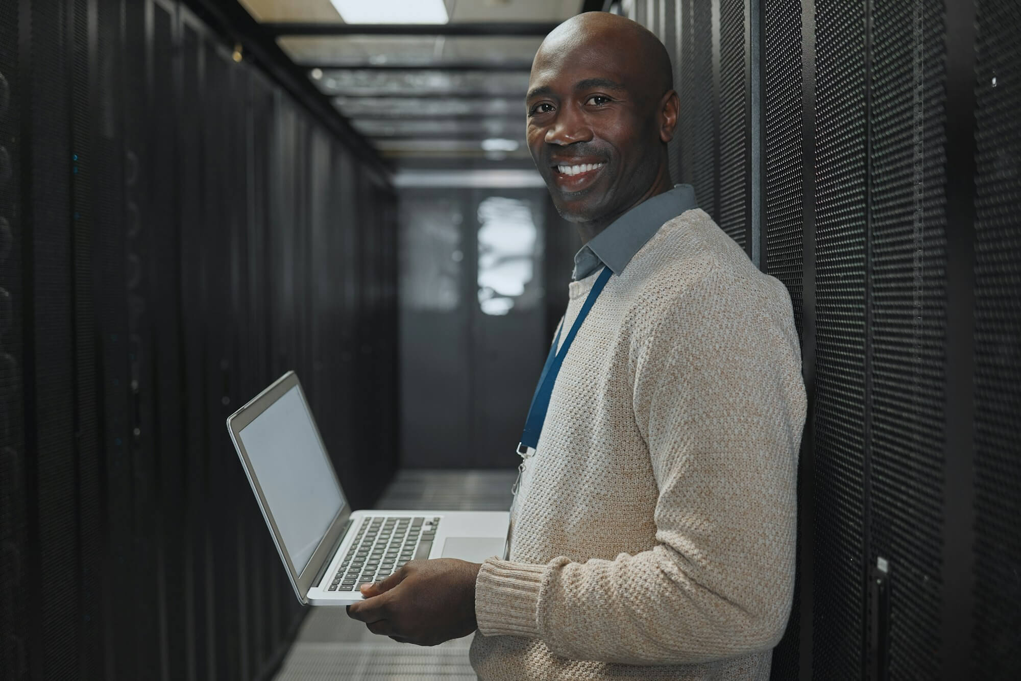 server-room-laptop-and-man-portrait-or-technician-for-data-center-system-and-cybersecurity-code-.jpg